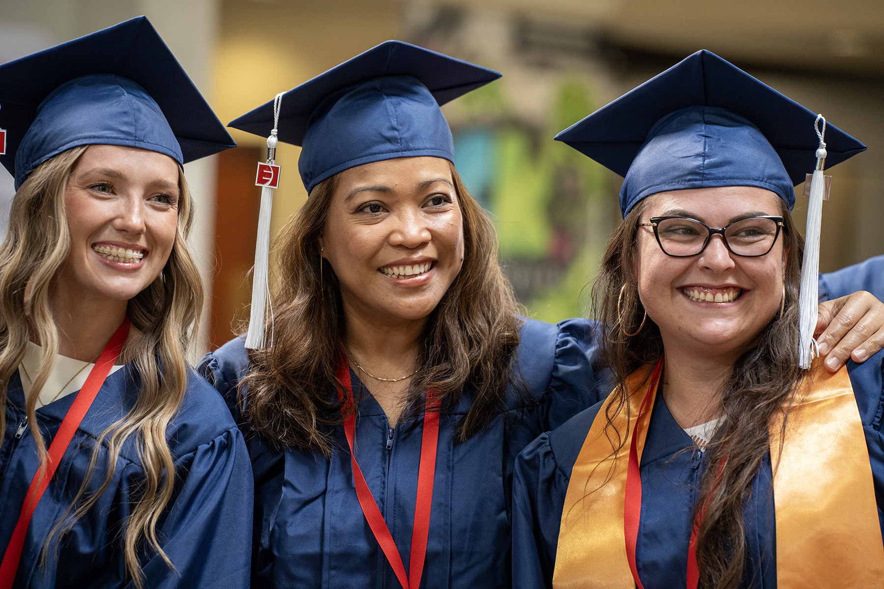Cassie Littrell posing with two fellow graduates on May 16, 2025