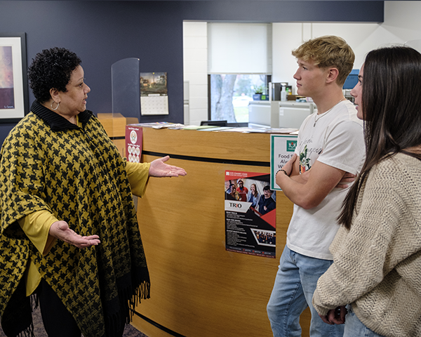 Student meeting with student advisor going over paperwork