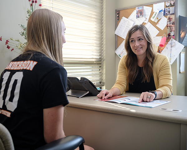 High School student meeting with a student services specialist