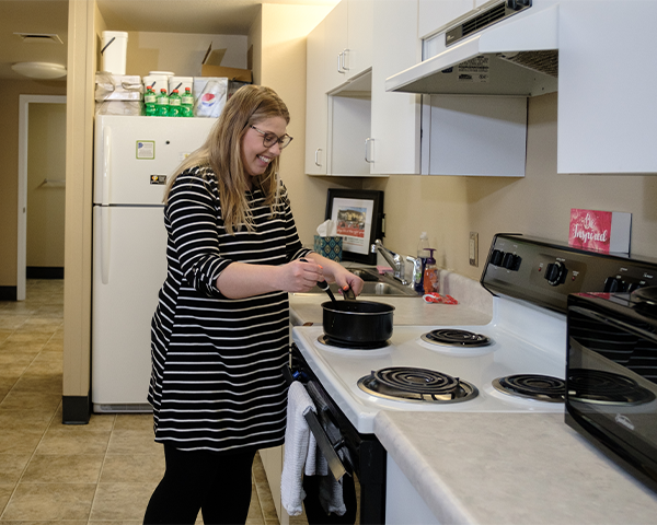 MCC Housing student apartment kitchen with student cooking