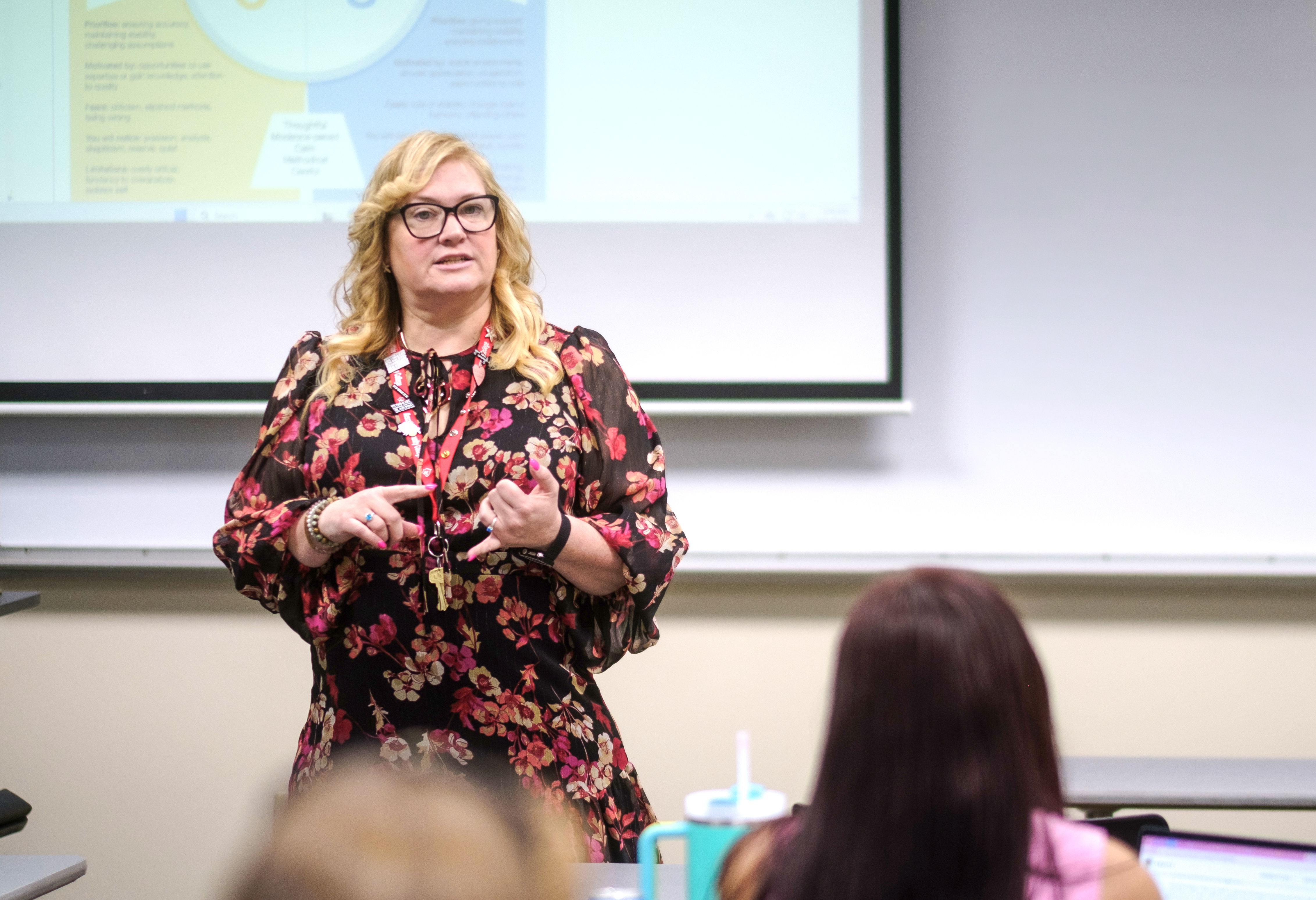 EICC Associate Professor Lori Sheppeard stands in a classroom on EICC's Muscatine campus teaching an introduction to psychology course.