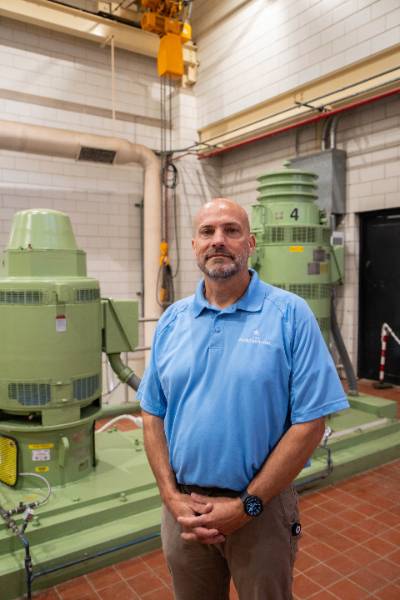 Tony Loete, vice president of operations for Iowa American Water, stands inside the company’s East River Station in Davenport, surrounded by water treatment equipment.